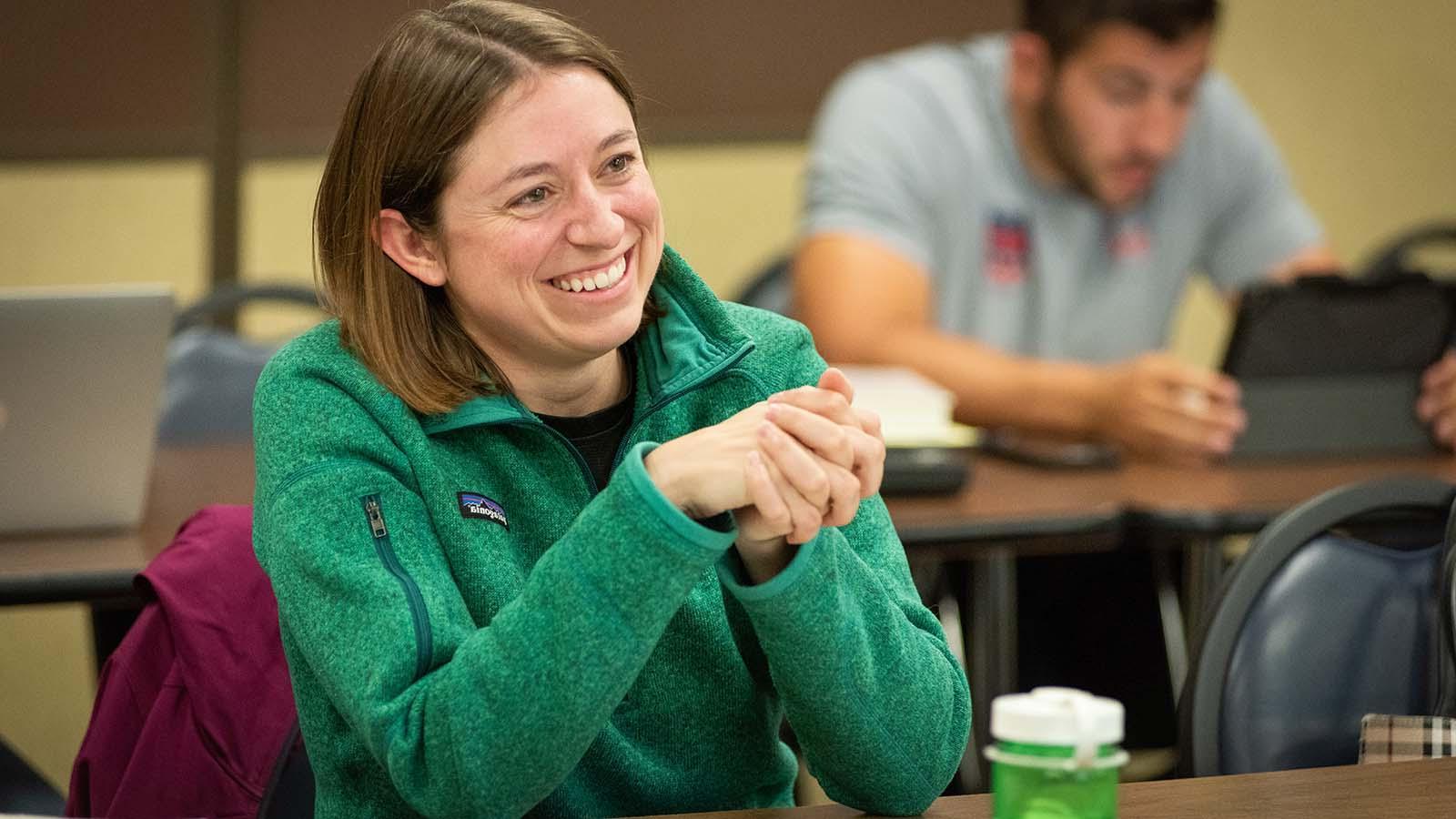 Alt text: Smiling adult student in class 